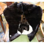 A shoulder pelt and faux fur hat.