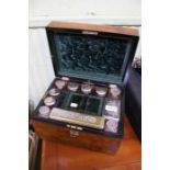 A 19th century walnut vanity box with silver plate lidded contents