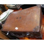 A vintage leather suitcase with initials B.E