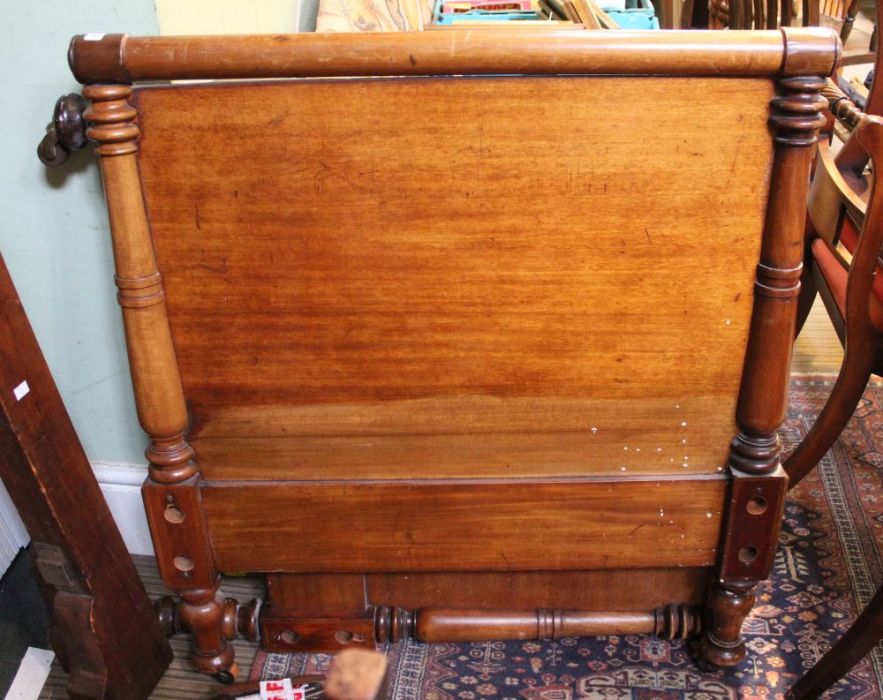 A late 19th / early 20th century mahogany framed single bed, the solid head & foot board having pila