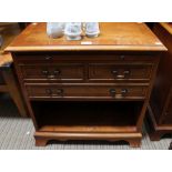 A three drawer cabinet with brushing slide yew wood