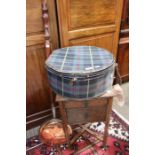 A two drawer bedside with a tartan hatbox and a copper warming pan