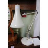 A cream angle-poise desk lamp