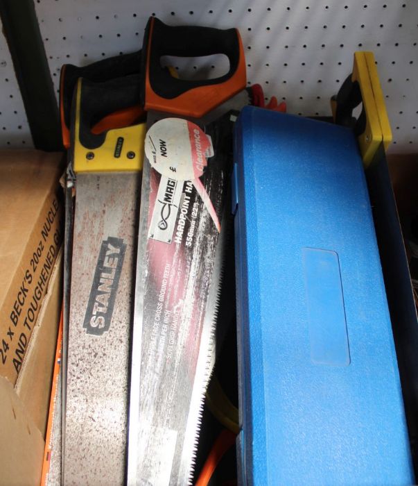 A box containing a selection of hand saws boxed drill bits etc