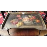 A painted tray on folding legs