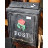 A modern wall mounted metal post box with rose design
