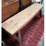 A probably 19th century elm topped pig bench of typical form & construction, 153cm long