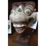 A painted Balinese mask, on stand - Felix Dennis collection