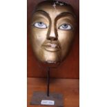 A far Eastern gilded mask on metal support - Felix Dennis collection