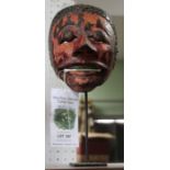 A painted Balinese mask, on stand - Felix Dennis Collection