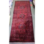 A red and black geometric pattern woven long rug
