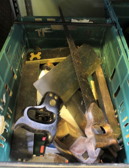 A crate containing vintage planes, saws, etc.