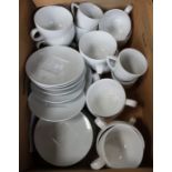 A box of Nespresso white cups and saucers