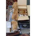 A cased manual typewriter, together with a boxed Whitefriars amber glass water set, a boxed Nao figu