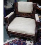 An upholstered show-wood Victorian armchair