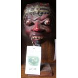 A painted Balinese mask, on stand - Felix Dennis collection