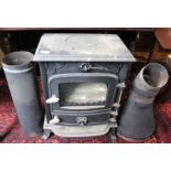 A log burning stove, cast iron with some flue sections