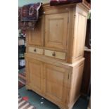 A 19th century stripped pine two piece House Keepers cupboard, having two upper doors over two drawe