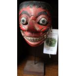 A painted Balinese mask, on stand - Felix Dennis collection