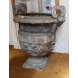 A lead garden urn, having horned pan mask handles, the body with acanthus scrolls, 84cm high to top