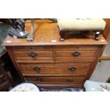 An early 20th century two over two oak chest of drawers