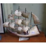A working novelty lamp made from horn depicting a sailing ship