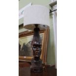 A carved African hardwood female figure head lamp with shade