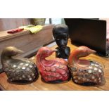 Three wooden birds and an African carved female bust