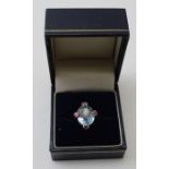 An Aquamarine ladies dress ring, 18ct gold mounted, set four rubies, ring size K