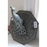 A modern cast metal peacock sundial