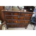 An 18th century two over three walnut fronted chest of drawers