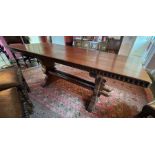 An oak refectory table of double pegged construction, the leg carved with a beetle motif