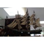 A model of a three mast clipper sailing ship on stand