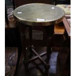 A small circular brass topped occasional table