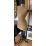 A vintage dress makers manakin on wooden stand