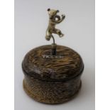 A "Tigger" trinket box, the turned exotic wood box, mounted with a sprung silver "Tigger" figurine,