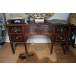 A mahogany 19th century desk, carved edging with five fancy drawer fronts