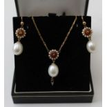 An 18ct gold necklace with enamel floral design pendant suspending a single cultured pearl, together