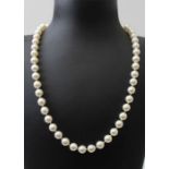 A strand of pearls necklace, fitted an enamel and diamond set clasp, length of pearls excluding the