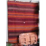 A hand woven Kelim carpet stripes in orange, brown and olive with decorative devices