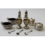 Stokes and Ireland Ltd, a pair of Georgian design silver pepper pots, Chester 1919, together with a