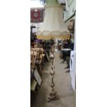 A tall gilt metal standard lamp with shade