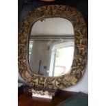 A large carved wooden framed plain plate wall mirror, with gilt finish
