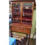 An Edwardian mahogany display cabinet, with dentil cornice over a base fitted three drawers on squar
