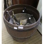 A plastic barrel containing a galvanised bucket, fireside companion etc