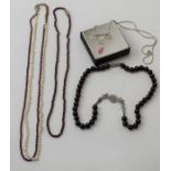 A collection of four various necklaces, includes garnets and pearls