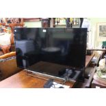 A Sony Bravia flat screen 40 inch television with remote and instructions