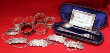 A silver cased christening set, comprising fork and spoon, four silver napkin rings, two silver plat