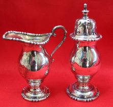 A pair of Chester HM silver cream jug and sugar sifter 217gms