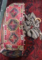 A nomadic kilim bag with a woven tent pull